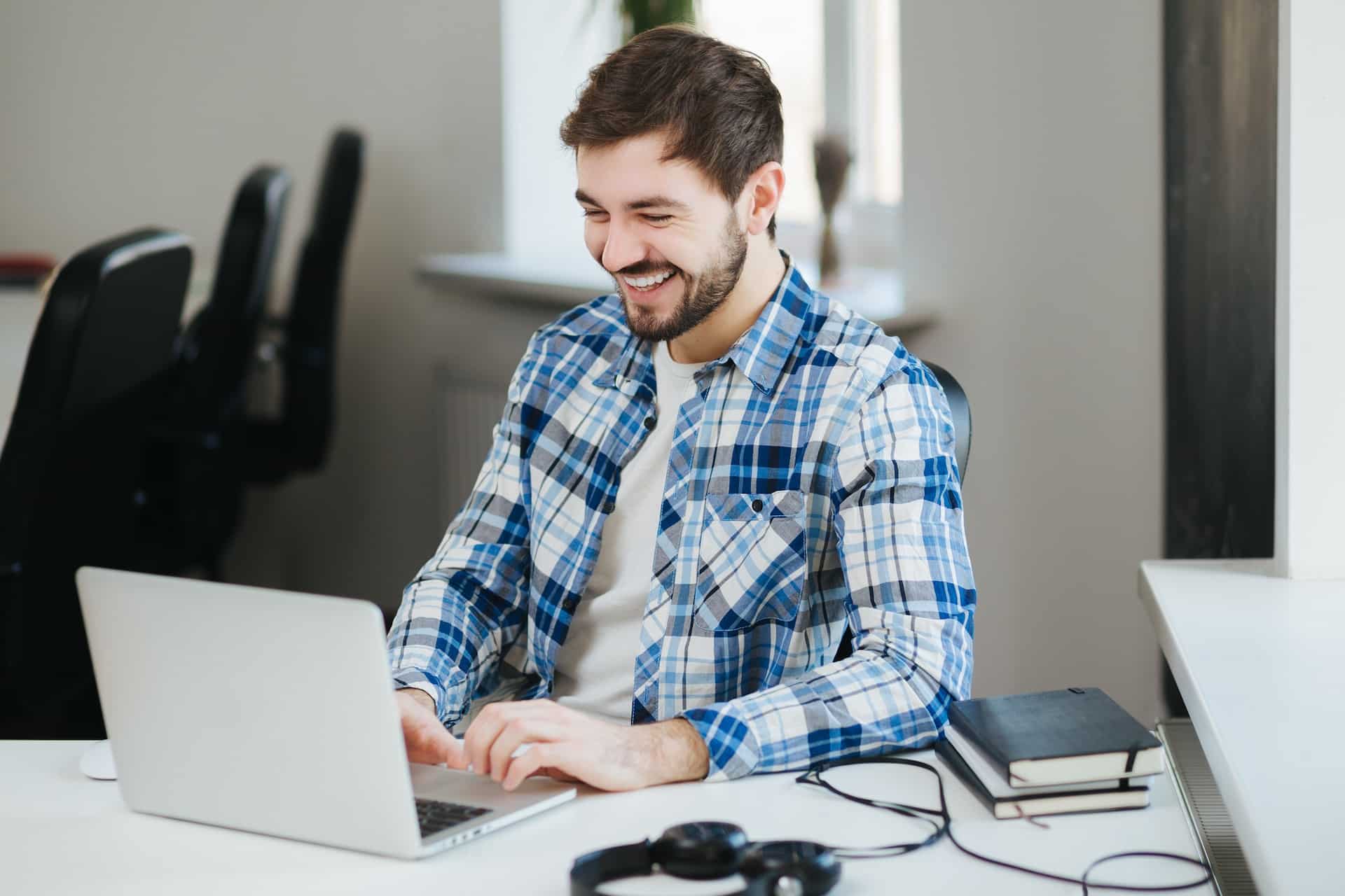 A man working on his laptop for a small business.