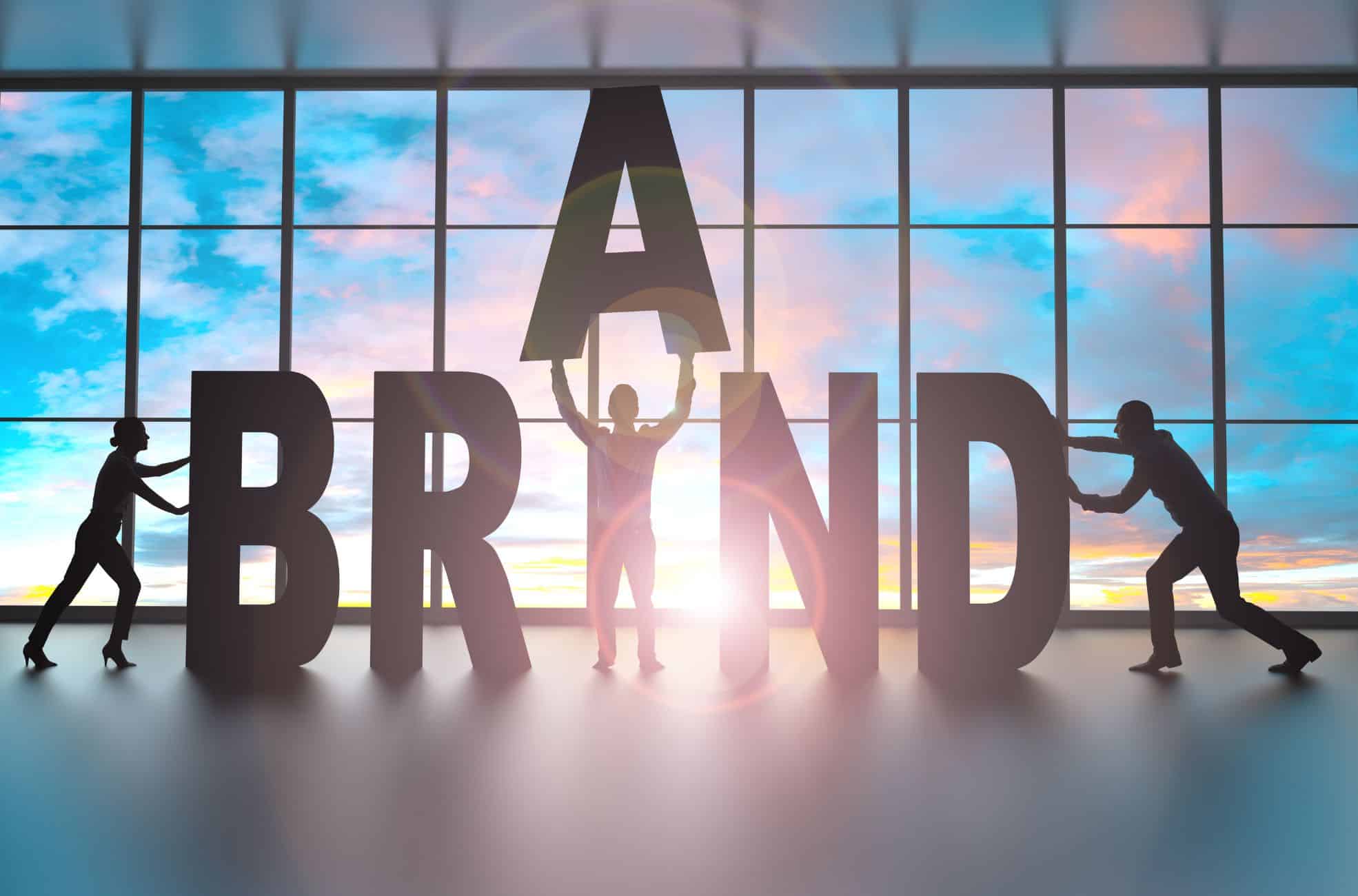 Stock Photo Of People Building The Word Brand With Giant Letters.