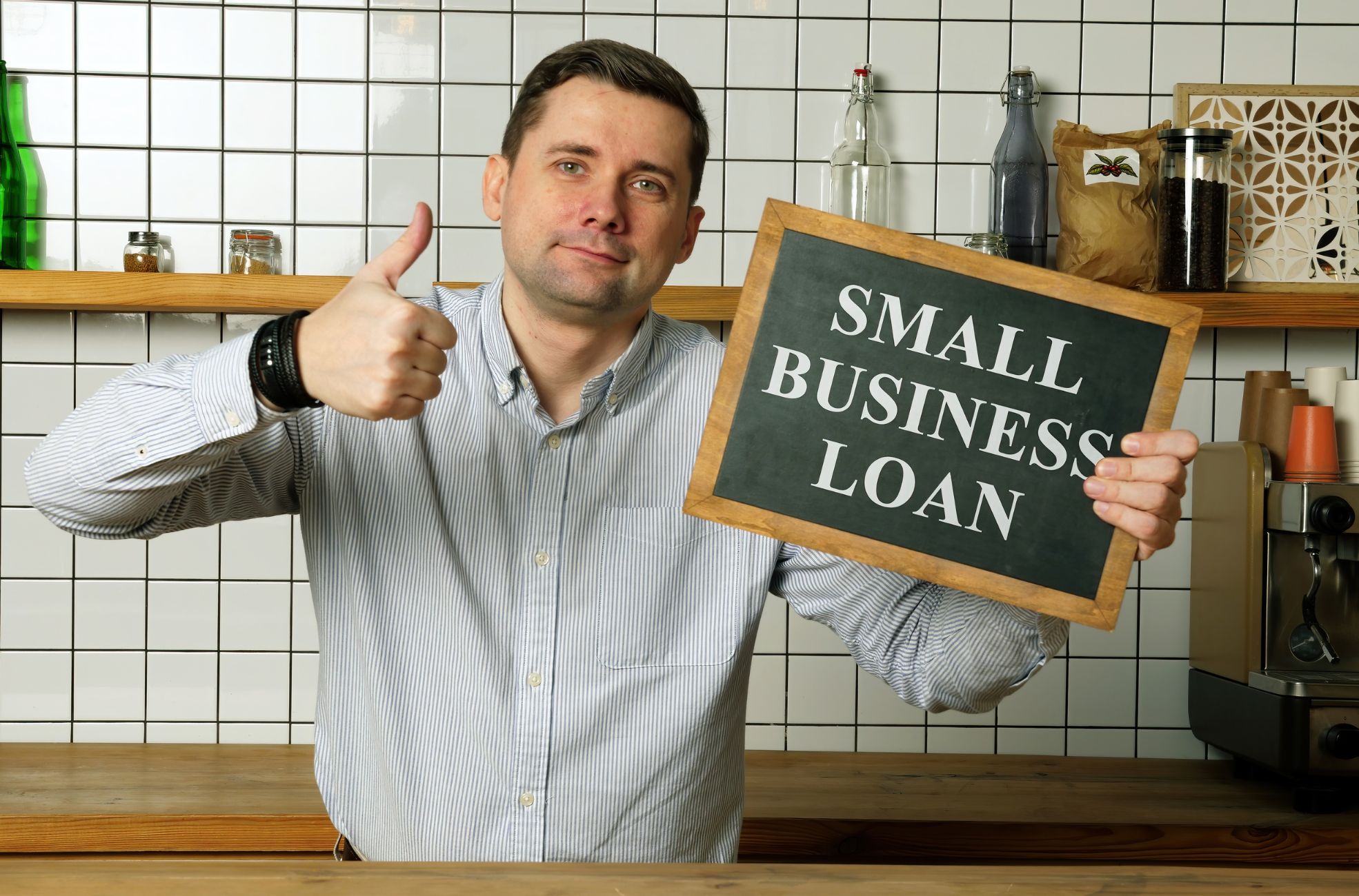 Man Holding Sign Saying Small Business Loan