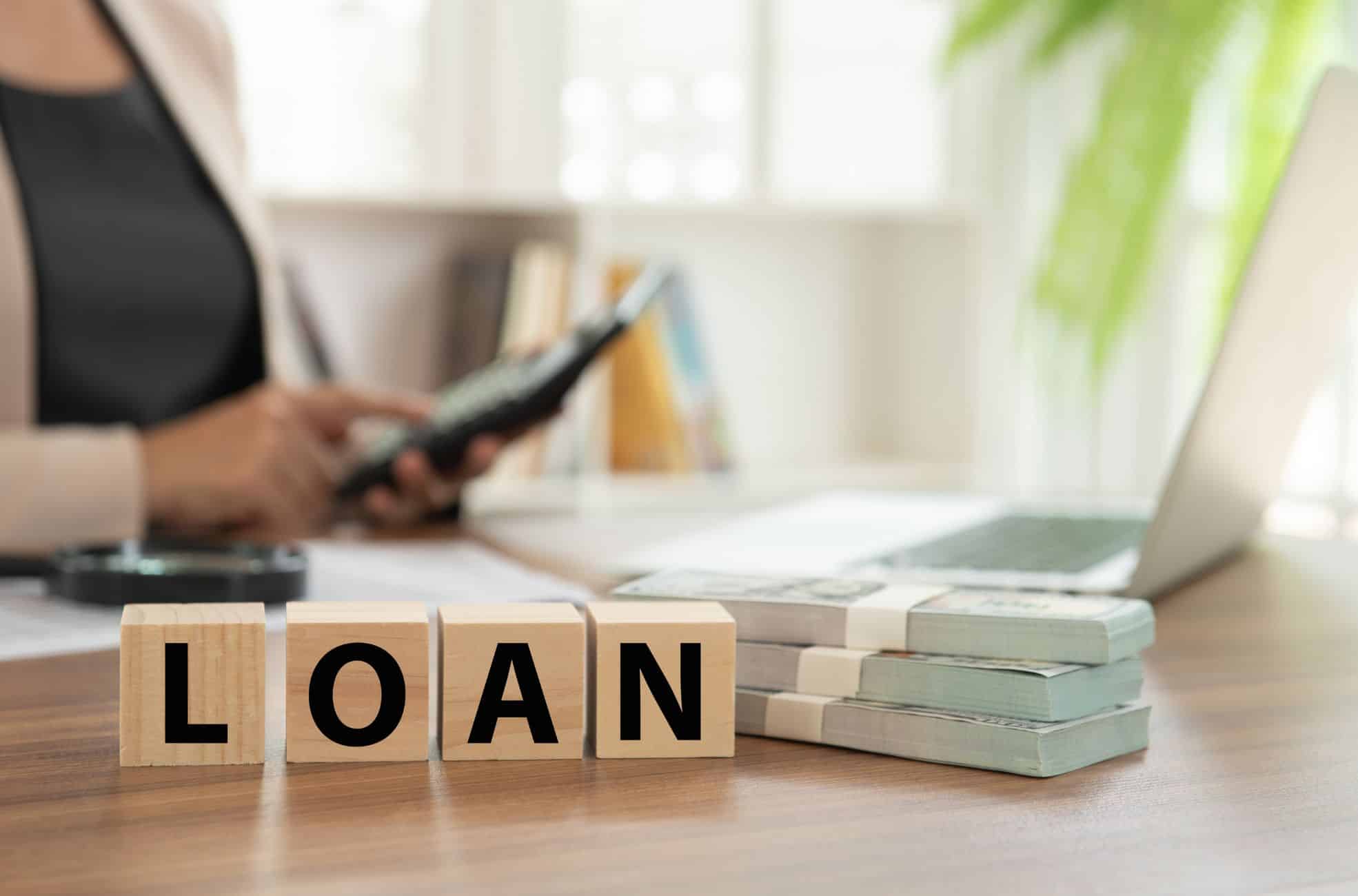 Desk With Blocks Spelling Loan In Capital Letters