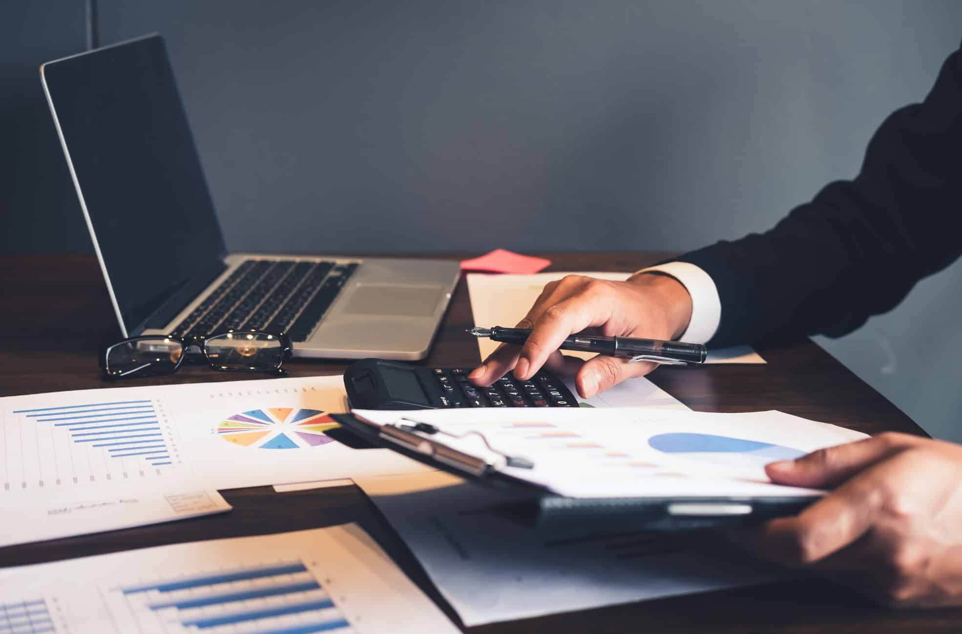 Businessman Doing Accounting At Desk