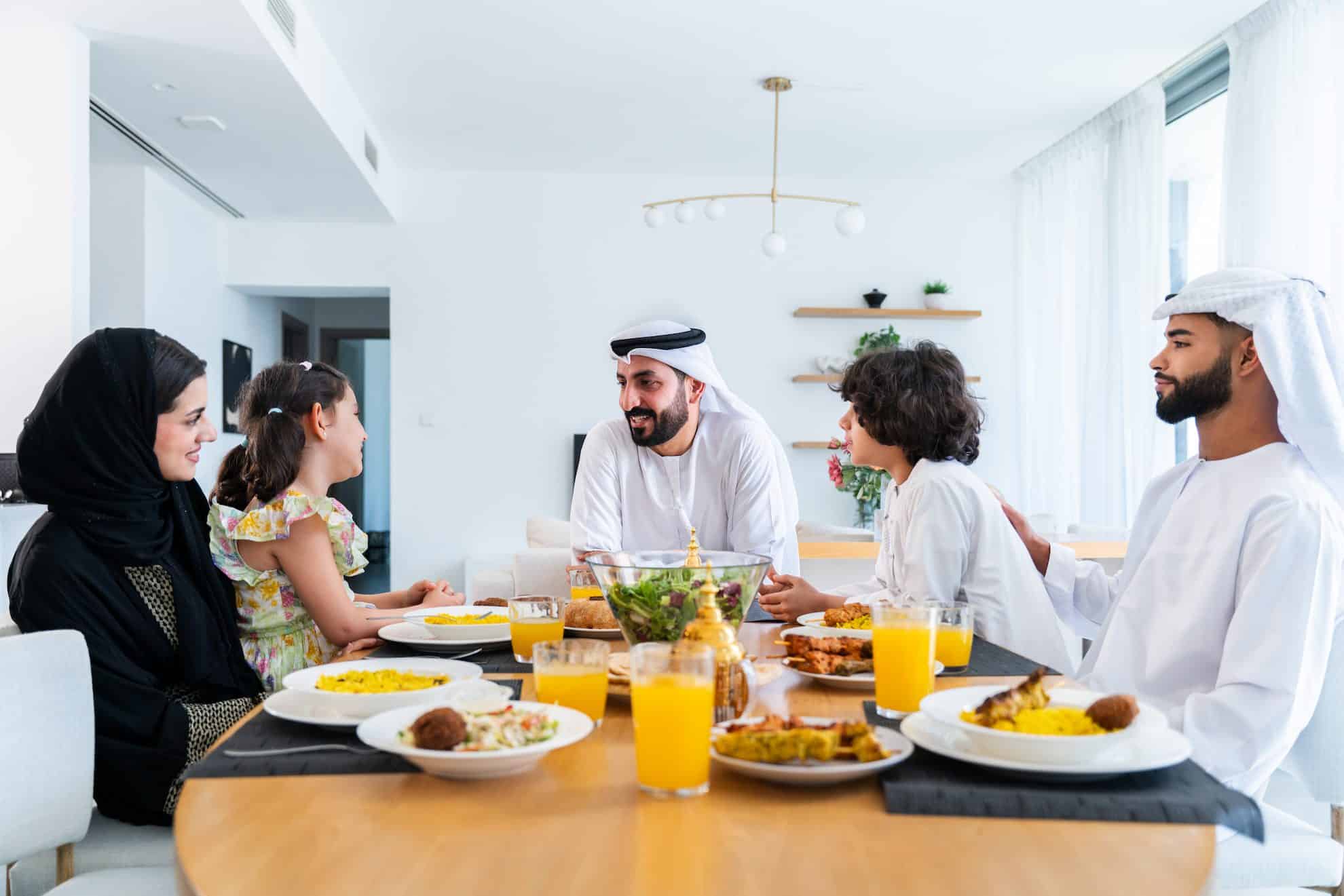 An Arabian family eating an affordable home-cooked meal in Dubai.