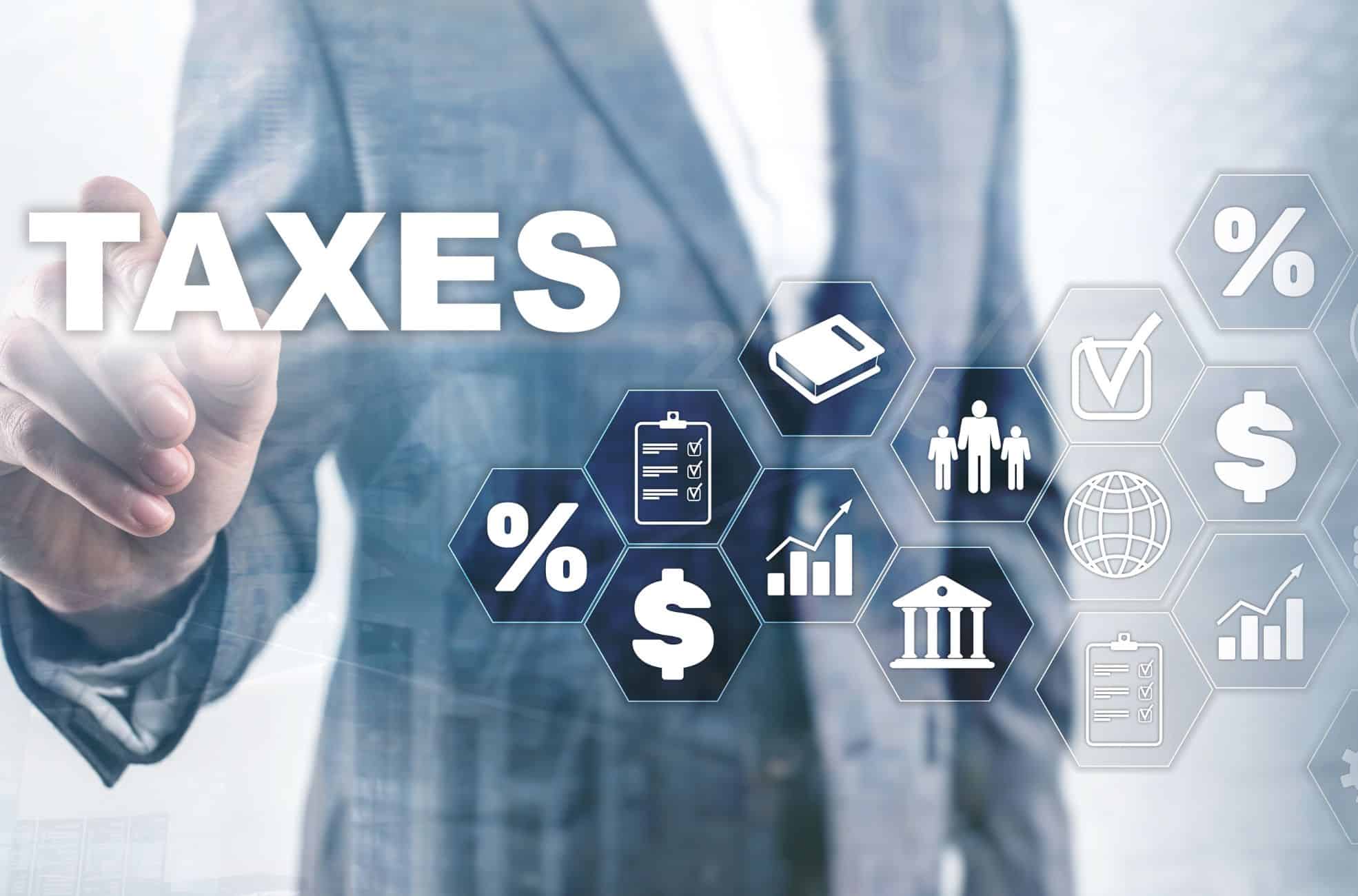 Business Man Pointing To Words About Tax