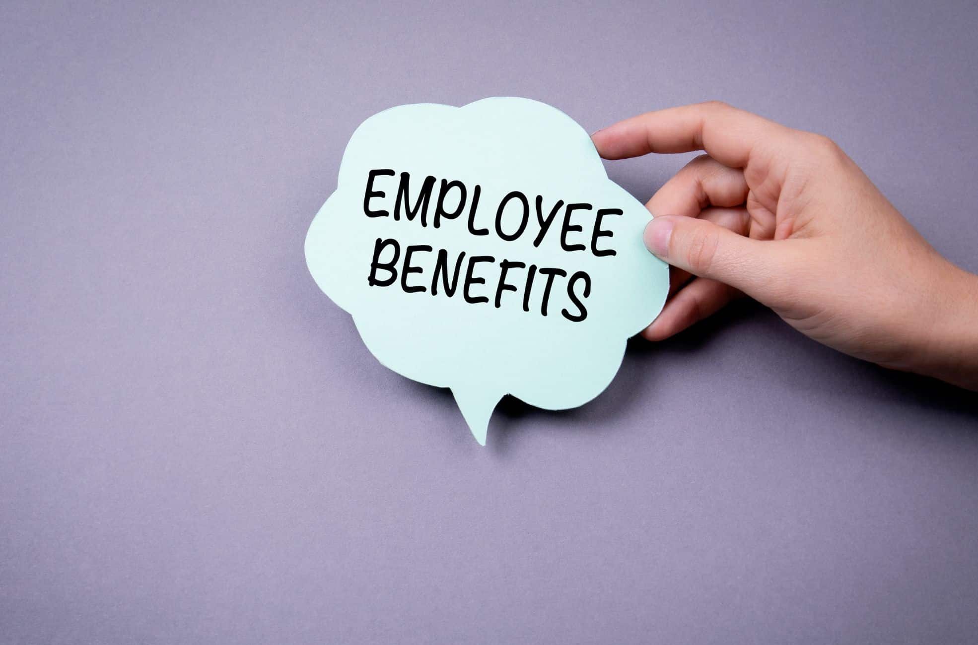 Hand Holding Sign Saying Employee Benefits