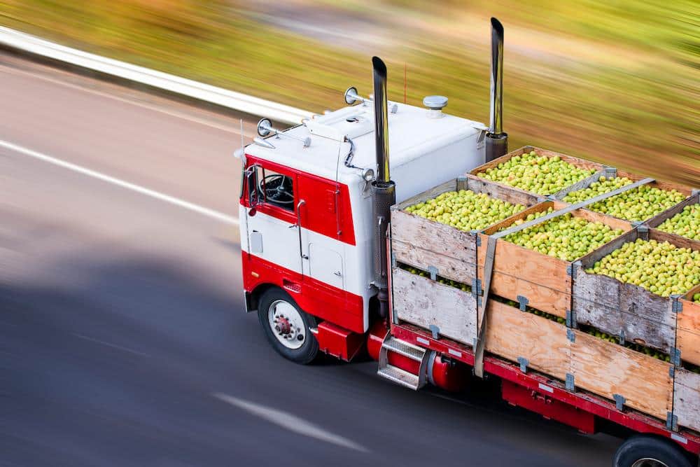 Truck delivering apples with their foodstuff trading license in Dubai
