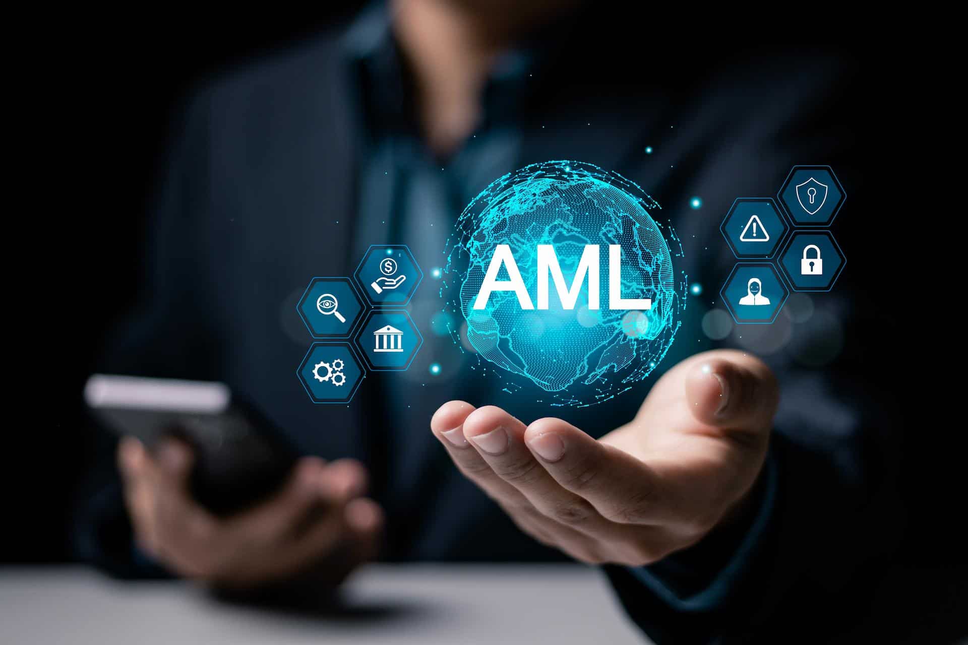 Business man holding a phone and reaching out to an AML graphic signifying goAML