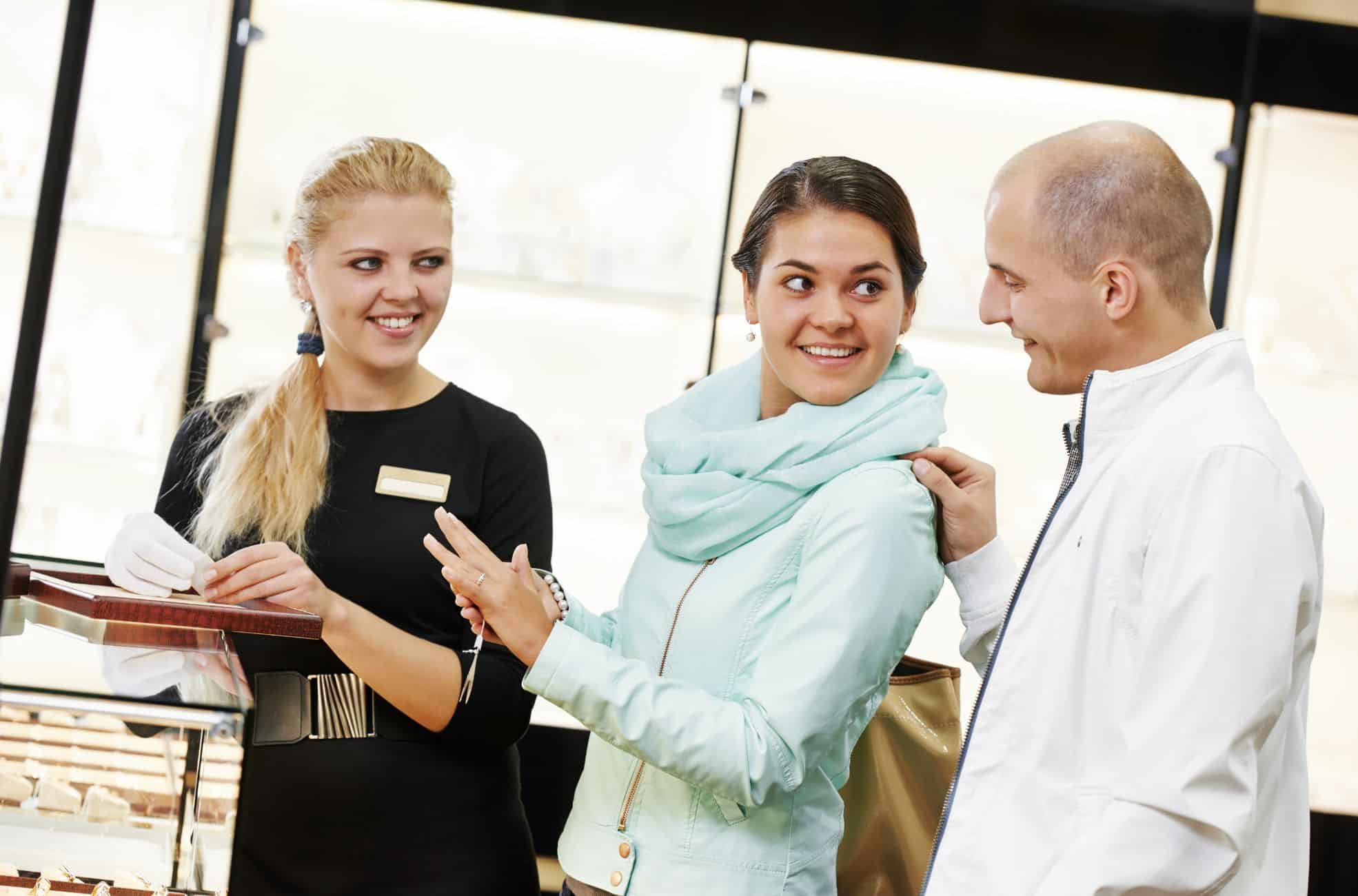 Woman With Clients In Jewellery Store