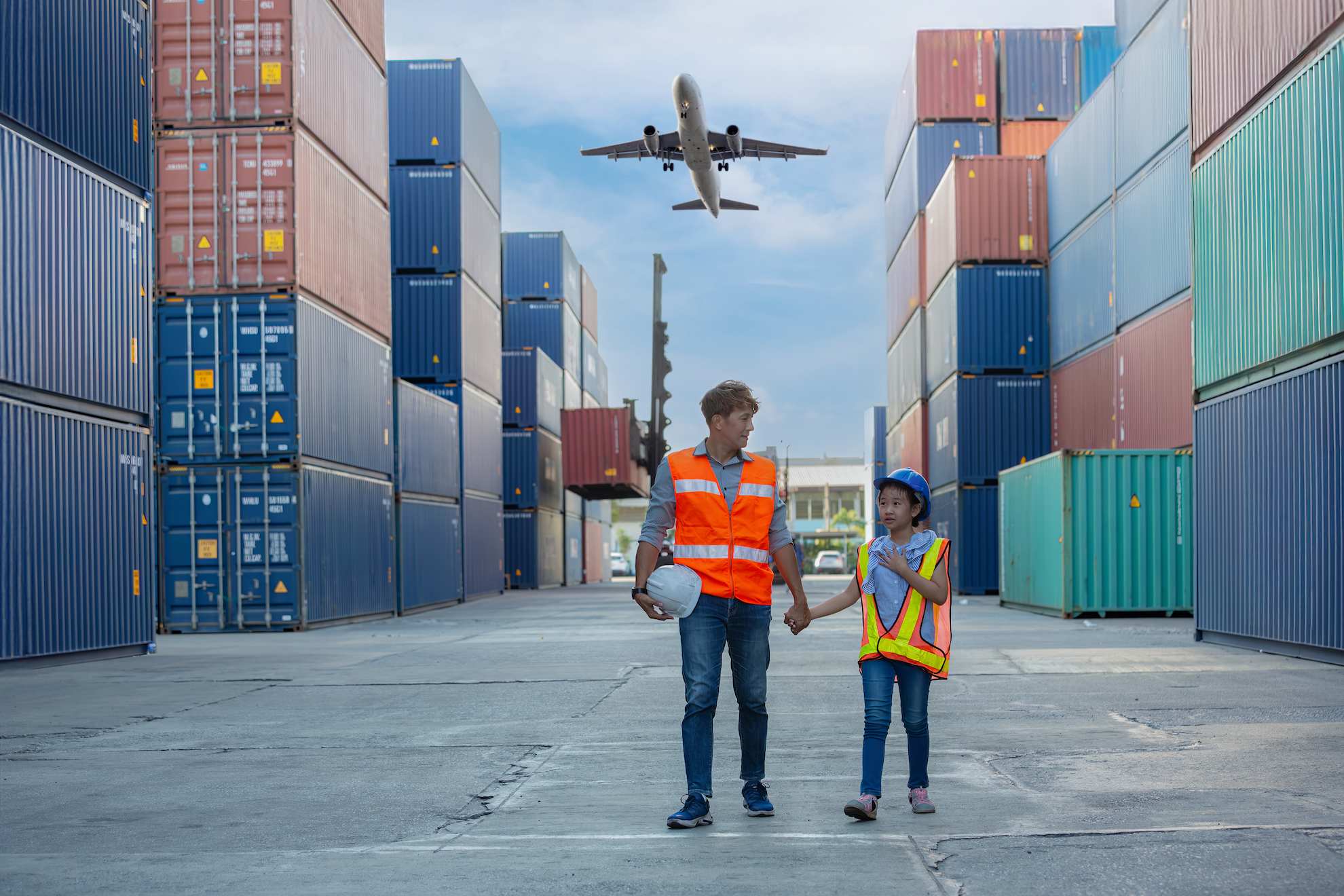 A picture of freight containers and a plane for import export trade in Dubai.