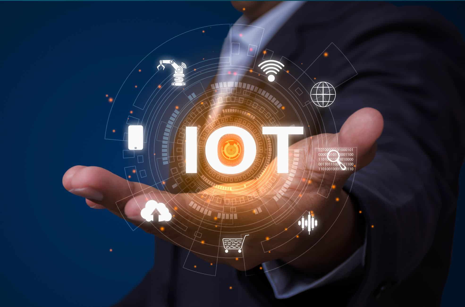 Businessman Holding Sign Reading "IOT"