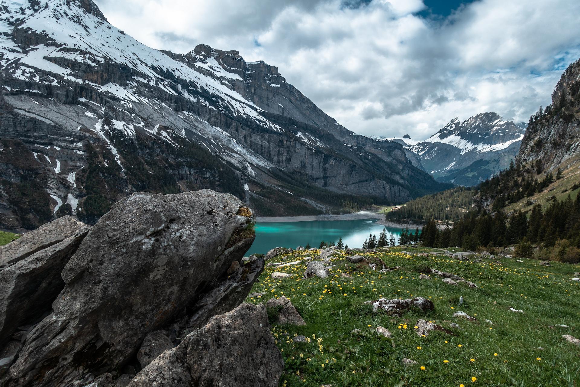 A still body of water, surrounded by mountains in Switzerland.