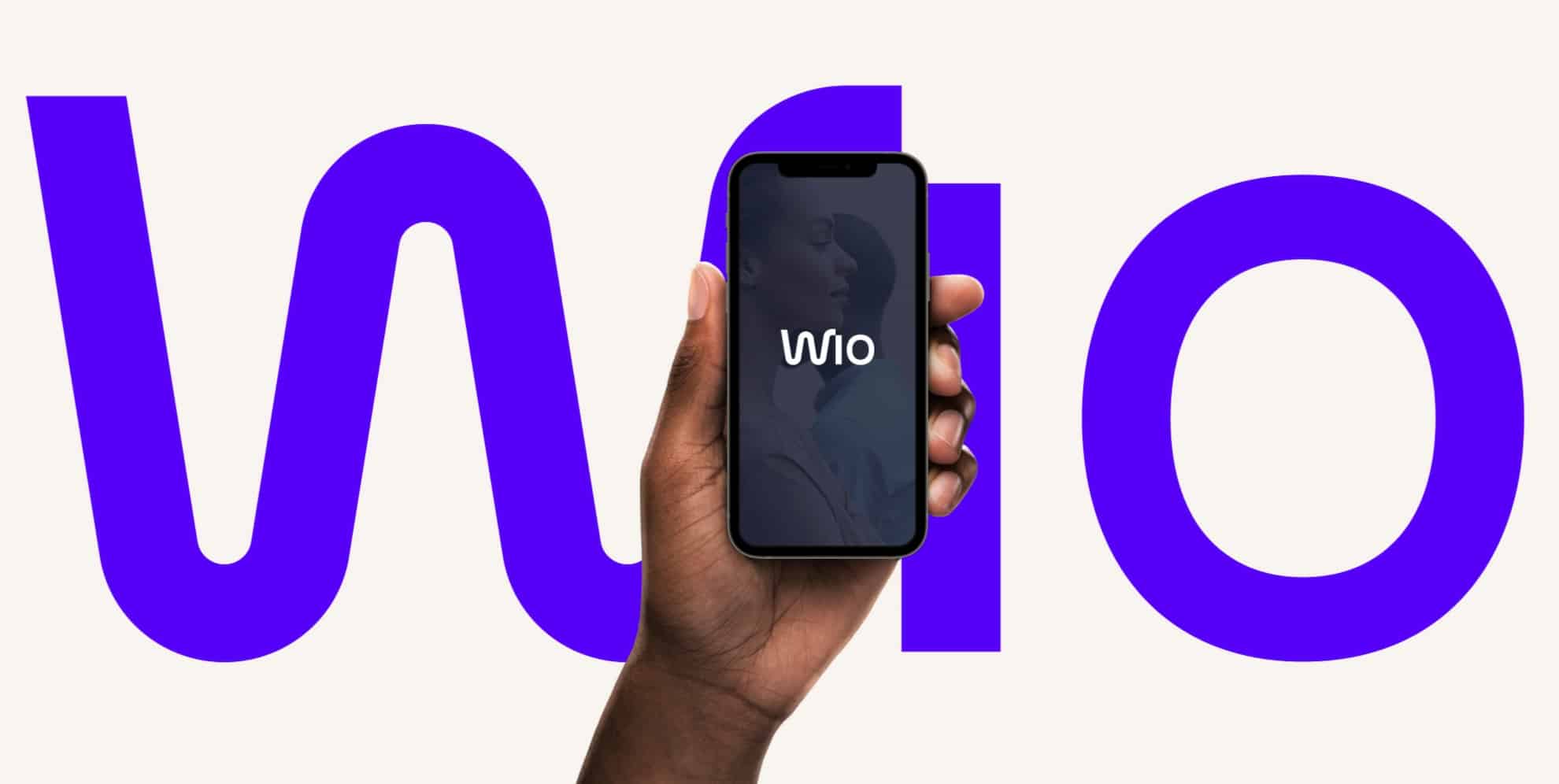 A photo of someone holding a phone, signing into Wio (the online banking app in the UAE).